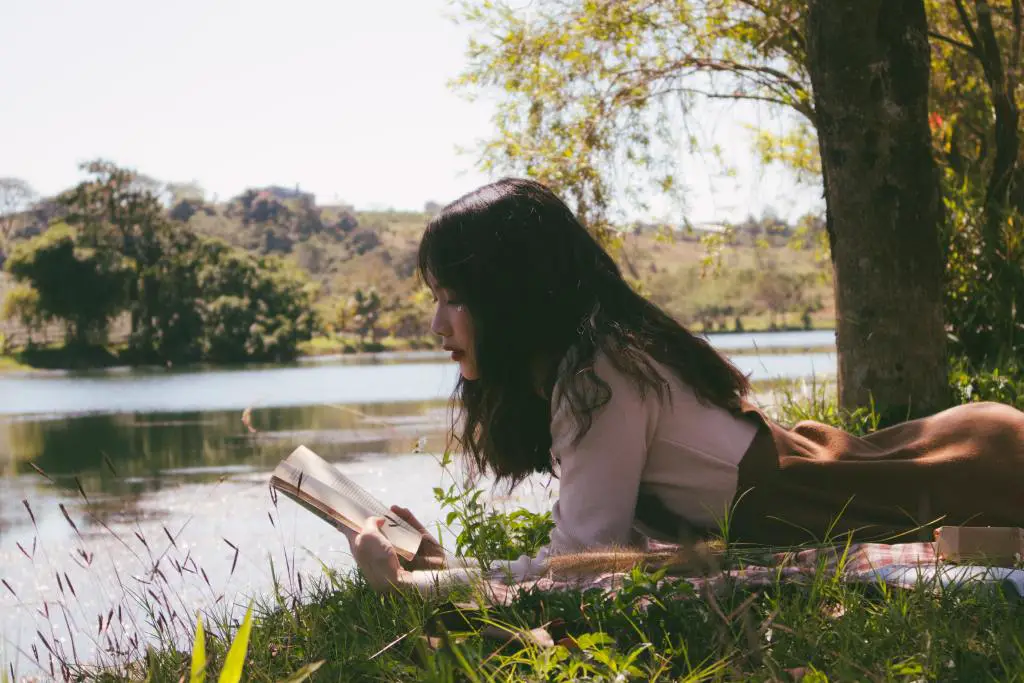 Girl reading by the river