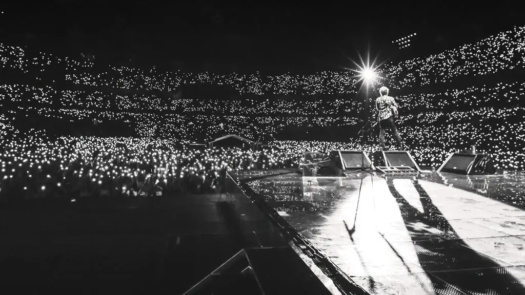 Ed Sheeran playing in front of a crowded stadium