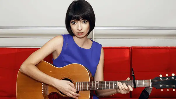 Kate Micucci playing guitar